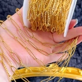 Macro detail of gold stainless steel diamond-cut oval link chain on a white spool - Gold-6x21.5
