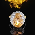 Luxury oval champagne gemstone ring with brilliant zircon halo on a black mirror surface - US 5 / Champagne