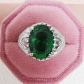 Close-up of vintage emerald ring with green stone in a pink velvet jewelry box - US 9 / Green