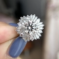 Detailed close-up of a luxury snowflake ring with a large zircon and sunburst halo design - US 10