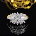 Macro view of silver flower ring with princess cut cubic zirconia and gold accents - US 6 / White