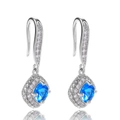 Detail view of silver drop earrings with square blue gemstone and diamond halo setting - Aqua