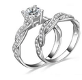Exquisite bridal jewelry set with round brilliant center stone and pavé twisted bands - US 10 / White