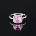 Luxurious silver ring featuring a pink cushion-cut gemstone with a halo of small diamonds - Size 6 / Pink