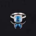 Elegant silver halo ring featuring a large cushion cut blue gemstone and pave diamonds - Size 6 / Blue