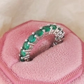 Elegant silver band ring featuring sparkling round-cut green zircon gemstones in claw setting - Green