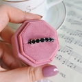 Elegant silver ring with black cubic zirconia in a pink velvet box with a vintage background - Black