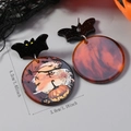 Detail view of Halloween acrylic earrings featuring pumpkin moon print and bat stud design - Witch and Pumpkin Style (WEH5517)