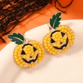 Halloween pumpkin seed bead earrings with crystal accents and green leaf details - Yellow Artificial Pearl