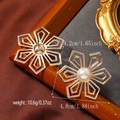 Detailed view of vintage gold floral earrings with pearls on a satin background - Hollow Six-Petal Flower Pearl Gold Style (WEH4826)