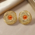 Detail of vintage gold spiral earrings with amber resin stones on silk background - Radial Spiral Amber Stud Earrings / Orange (WEH4974)