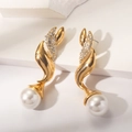 Macro detail of vintage gold twist earrings with sparkling rhinestones and white pearls - Streamlined Rhinestone Large Pearl Dangle Earrings (WEH5614)