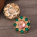 Macro detail of retro gold earrings with emerald and pink crystals on wood background - Pink and Green Color Block Vintage Earrings (WEH5603)
