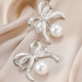Elegant silver bow earrings with round white pearls on luxury champagne silk background - Silver Bow Pearl Stud Earrings / Eco-friendly White K