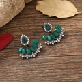 Close-up of vintage resin drop earrings with green crystals and rhinestones on wood - Gun Black Green Fan Style (EH5560)