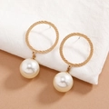 Elegant gold textured hoop earrings with white pearl pendants on soft fabric - White Gold Trim Pearl Ring (EH5737)