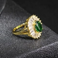 Macro view of emerald green zircon ring with sunburst halo and gold plated band - US 5 / Green