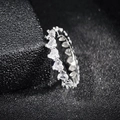 Close-up of eternity ring with heart-cut clear zircons on black textured background - US 5 / White