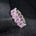 Close-up of sparkling oval pink zirconia stones set in a silver eternity band ring - US 5 / Pink