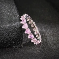 Close-up of pink heart-cut gemstones set in a silver eternity ring band for women - US 5 / Pink
