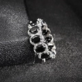 Close-up of black oval zircon ring with halo crystals on a matte black texture - US 5 / Black