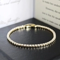 Golden tennis bracelet with 3mm square-cut cubic zirconia in a classic four-prong setting - 2.5MM-19CM / Gold