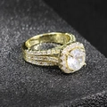 Detailed macro shot of a gold halo ring with a round center zircon and pavé diamond setting - US 5 / Gold