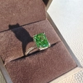 Macro detail of rectangle emerald ring with pavé diamond band in a velvet jewelry box - Number 5 / Green