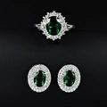 Detail showing emerald green stone ring and earrings set with halo diamond design - Green / Size 5