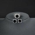Macro detail of luxury silver jewelry set with square black stones and white zircons - US 5 / Black