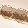 Polished gold bamboo hoop earrings displayed on a brown jewelry box in a studio setting - Smooth Large Hoop (en-1-e057-1)