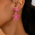 Detail of pink floral oversized earrings on model showing fashion street style size - Pink Hollow Double Flower Drop Earrings (en-19-e028)