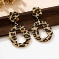 Detailed view of leopard print earrings with hammered metal texture on dark wooden surface - Irregular Rectangular Hammered Leopard Style (t-12-t044-3)