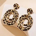 Macro shot of triple-layered oval leopard print earrings with gold trim on a stone stand - Triple Oval Nested Leopard Style (t-12-t045-2)