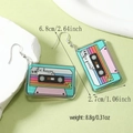 Detail shot of vintage cassette tape acrylic earrings with Be Happy text and rainbow stripes - Retro Cassette Style (WEH4746)