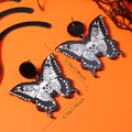 Detailed size view of dark butterfly acrylic earrings with skull and floral pattern - Black and White (WEH5322)
