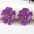 Detail of purple flower stud earrings featuring matte petals and golden textured centers - Purple