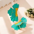 Detail of turquoise floral earrings with golden edges and yellow center accents - Green Ring Collection