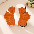 Detailed macro of orange enamel flower earrings with gold edges on display - Orange Ring Collection