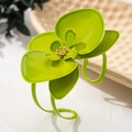 Detailansicht des grünen Orchideenarmbands mit eleganten goldenen Staubblättern - Grün