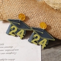 Detail van 2024 afstudeerhoed oorbellen van acryl met gele pailletten op vintage papier - Afstudeerhoedje 24 (WEH3557 Zwart Witgoud Verguld)
