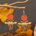 Cow head dangle earrings with sunflower pattern and orange wooden discs on branches - Tiered Sunflower Design (WEH3928)
