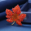 Luxurious maple leaf brooch with orange crystals and red rhinestones on a gold setting - Orange Gold