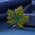 Luxurious green maple leaf brooch with sparkling crystals on golden metal base - Olive Green Gold