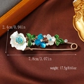 Detailed view of flower safety pin brooch with rhinestones and blue enamel petals - Lake Blue