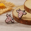 Detailed view of handmade wooden cow head earrings with rustic brown spots and wood grain texture - Dark Coffee Cow Print (WEH4311)