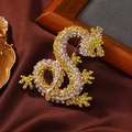 Lussuosa spilla a forma di drago con strass gialli e bianchi su base metallica oro - Giallo e Oro Champagne
