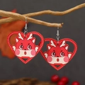 Close-up of red heart-shaped wooden earrings with a cute dragon mascot on a branch - Red (WEH4329)