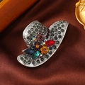 Macro shot of elegant hat-shaped brooch with colorful rhinestones on vintage silver alloy - Antique Silver Cowboy Hat