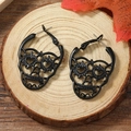 Gothic black skull hoop earrings for women with heart shaped eyes and hollow metal design - Black